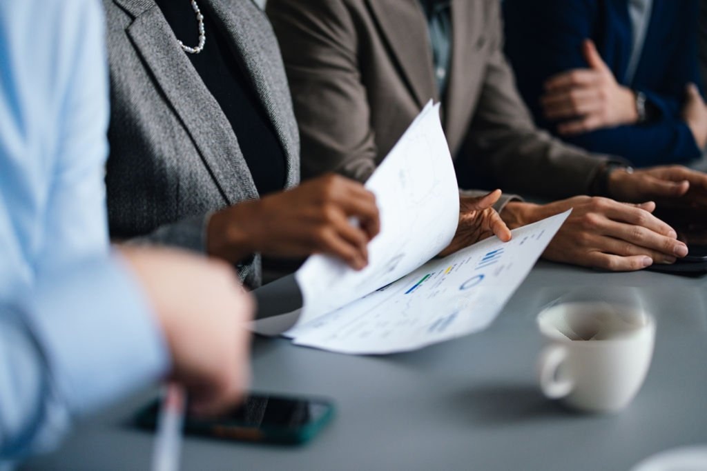 executives reviewing financial documents in boardroom